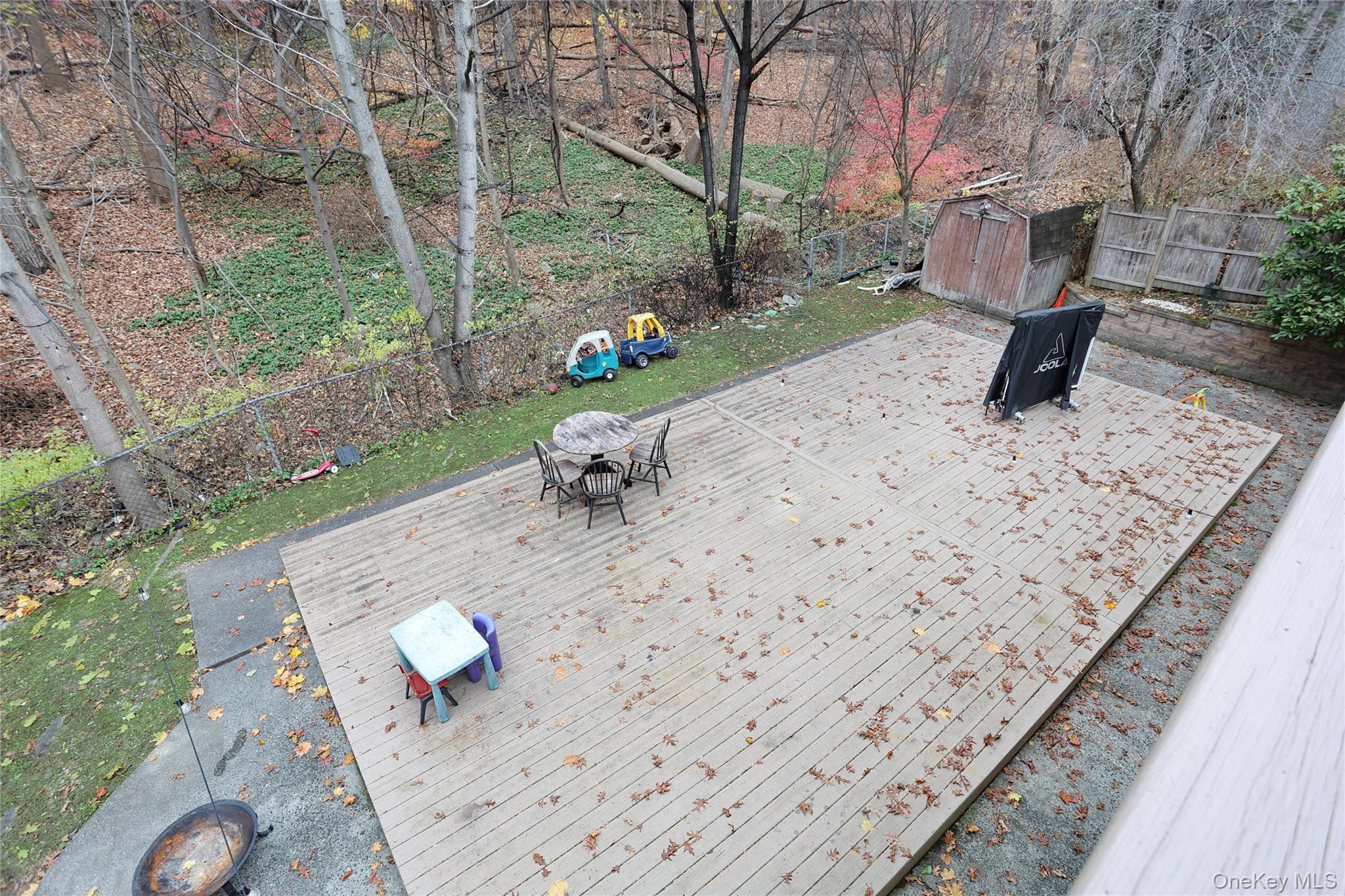 35 Regina Road Monsey, NY 10952 - Photo 22 of 34 Wooden terrace with a fenced backyard, a storage shed, and outdoor dining space
