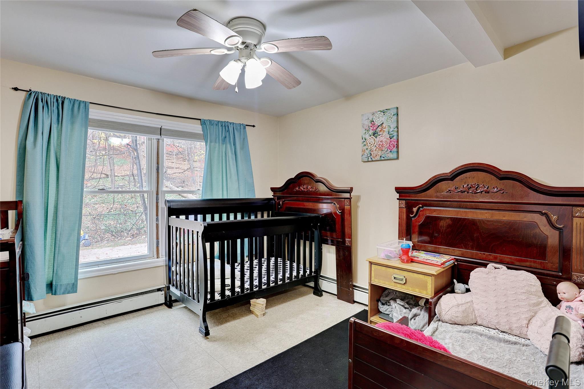 35 Regina Road Monsey, NY 10952 - Photo 27 of 34 Bedroom featuring baseboard heating, tile patterned floors, a ceiling fan, and a crib