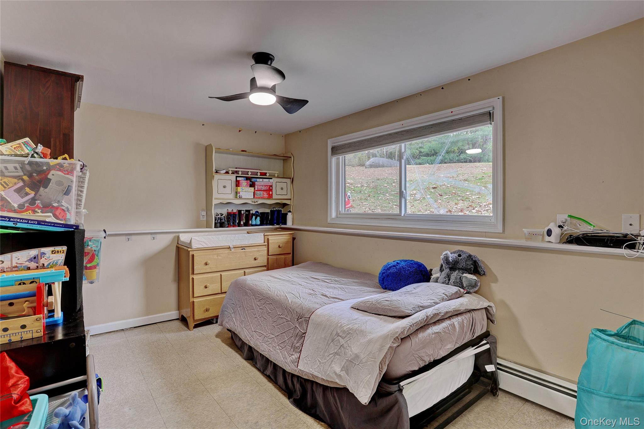 35 Regina Road Monsey, NY 10952 - Photo 29 of 34 Bedroom featuring light flooring, baseboard heating, and ceiling fan