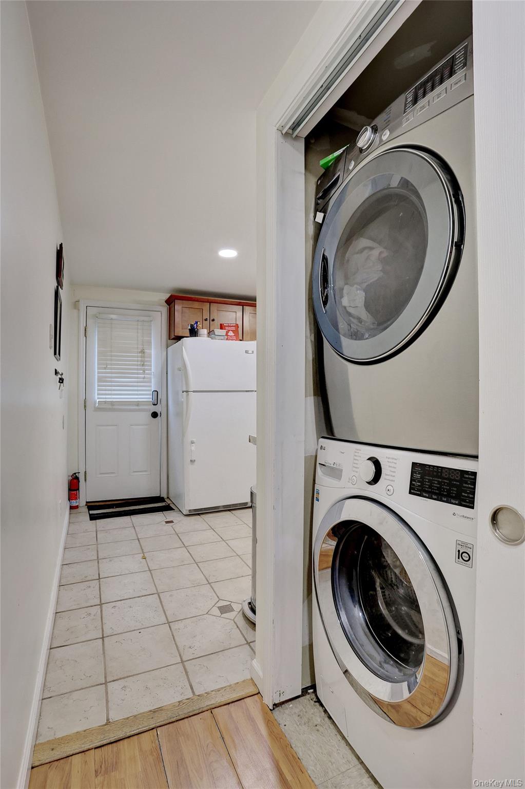 35 Regina Road Monsey, NY 10952 - Photo 31 of 34 Laundry room featuring stacked washing machine and dryer, light tile patterned floors, and recessed lighting