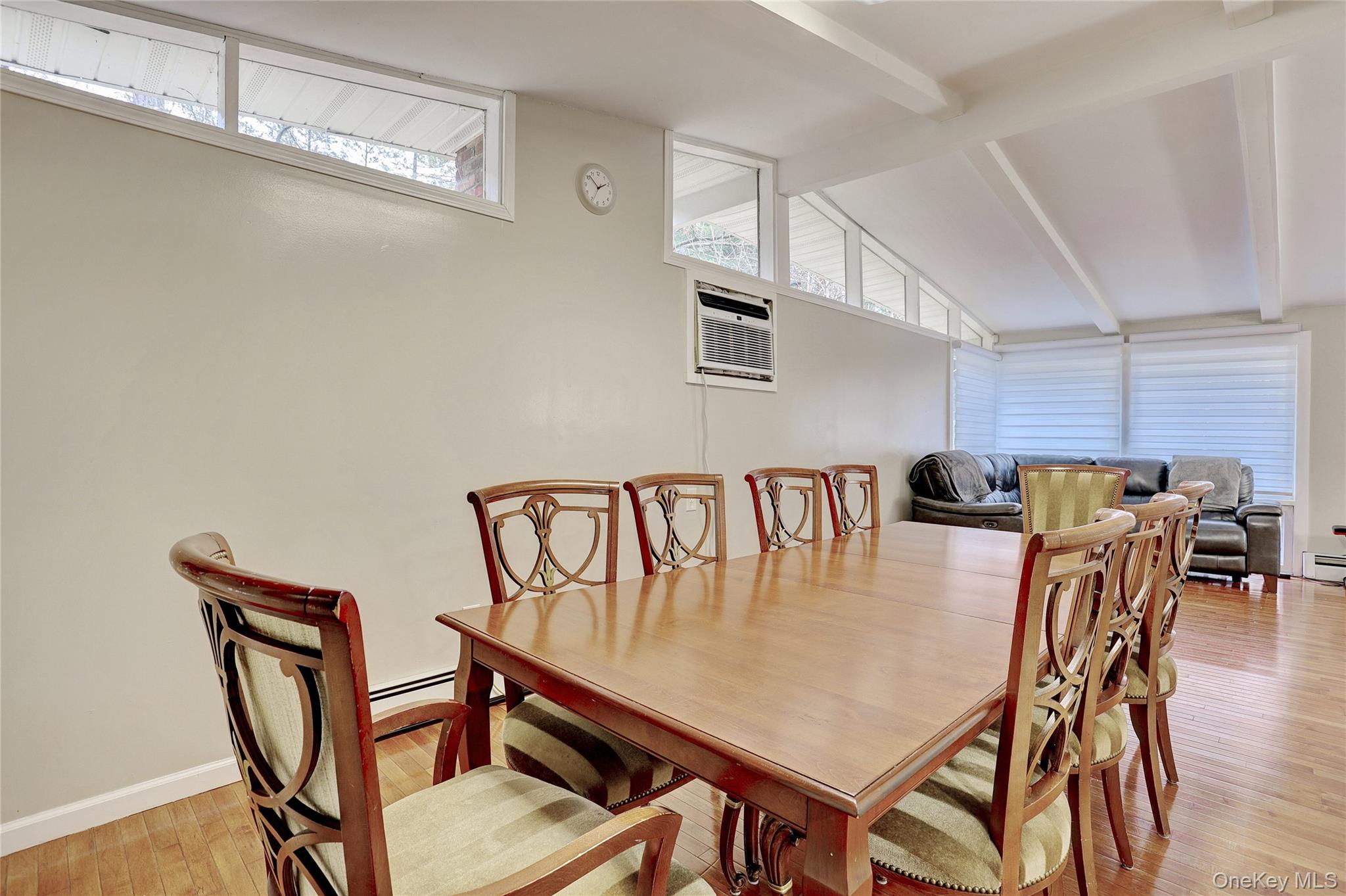 35 Regina Road Monsey, NY 10952 - Photo 9 of 34 Dining area featuring plenty of natural light, light wood-style flooring, a wall unit AC, and a baseboard heating unit