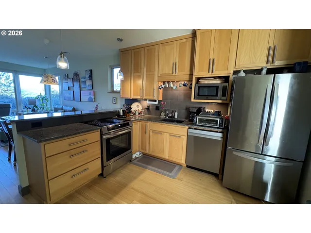 a kitchen with a refrigerator stove and sink