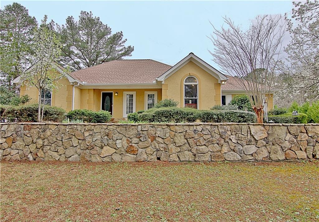 6915 John Rivers Road Fairburn, GA 30213 - Photo 1 of 1 a front view of a house with a garden