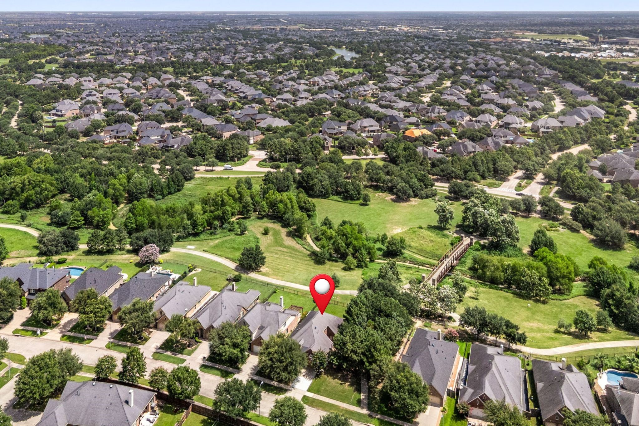 27642 Linden Ridge Lane Fulshear, TX 77441 - Photo 36 of 42 Another view of the surrounding area and neighborhood showcases the home within its scenic setting. The property has been pinpointed for your reference, making it easy to identify its exact location within the beautiful natural surroundings.