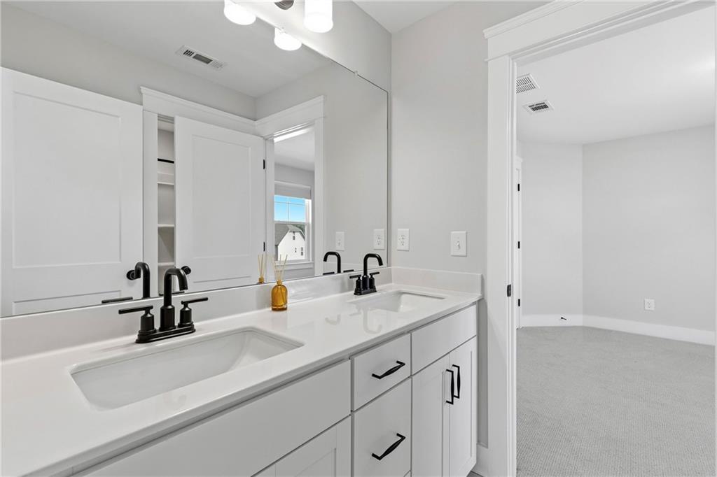 203 Sunshower Ridge Canton, GA 30114 - Photo 26 of 58 a bathroom with a sink and a mirror