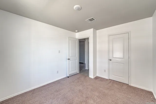 a bathroom with a granite countertop sink toilet a mirror and shower