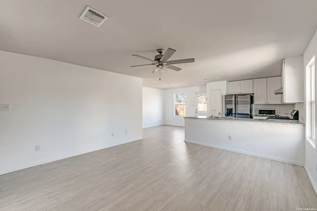 a view of a kitchen with a sink and a window
