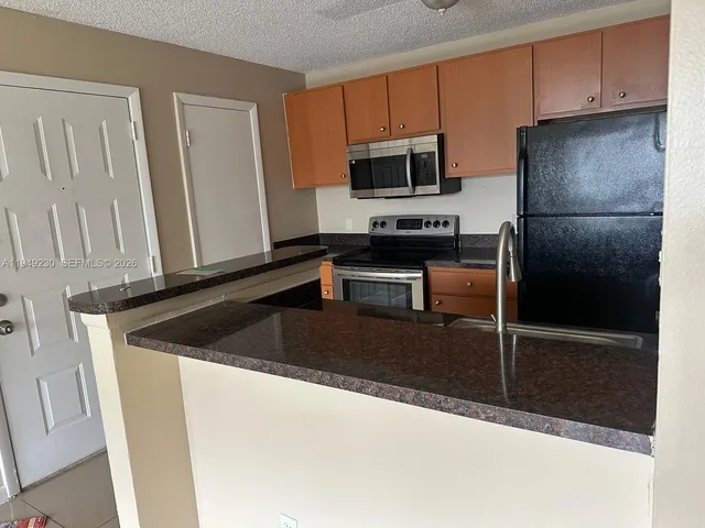 a kitchen with a sink and a refrigerator