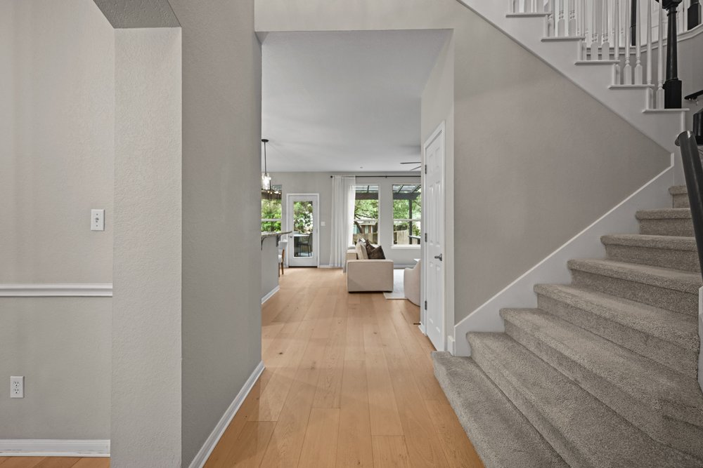 2823 Lantana Ridge Drive Austin, TX 78732 - Photo 5 of 34 a view of a hallway with wooden floor and furniture