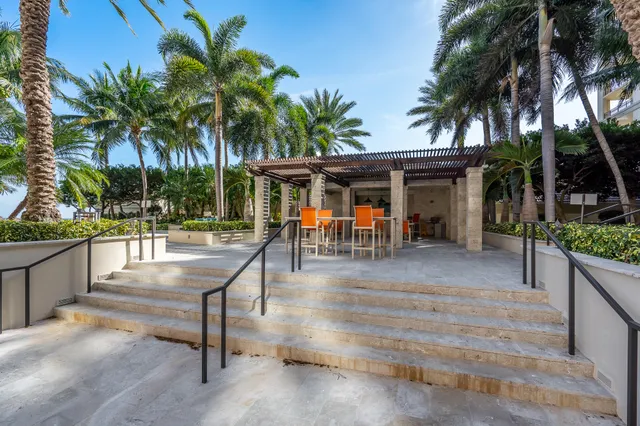a view of a patio with table and chairs and potted plants