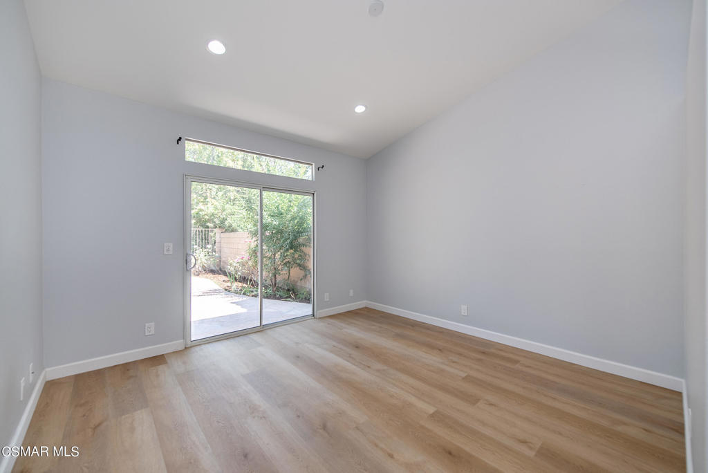 4774 Rhapsody Drive Oak Park, CA 91377 - Photo 14 of 34 an empty room with wooden floor and windows