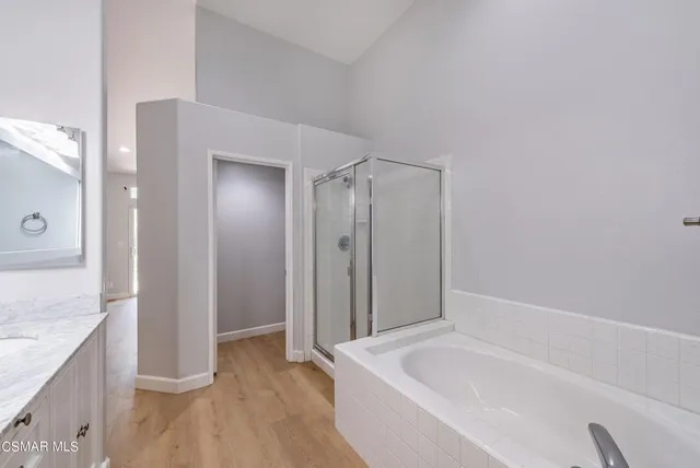 a spacious bathroom with a granite countertop tub sink and shower