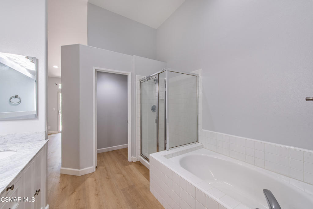 4774 Rhapsody Drive Oak Park, CA 91377 - Photo 18 of 34 a spacious bathroom with a granite countertop tub sink and shower