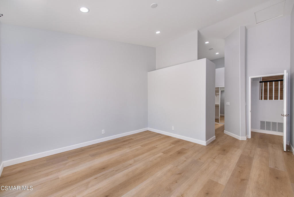 4774 Rhapsody Drive Oak Park, CA 91377 - Photo 19 of 34 wooden floor in an empty room with a kitchen