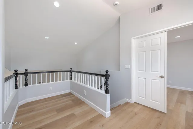 a view of hallway with wooden floor