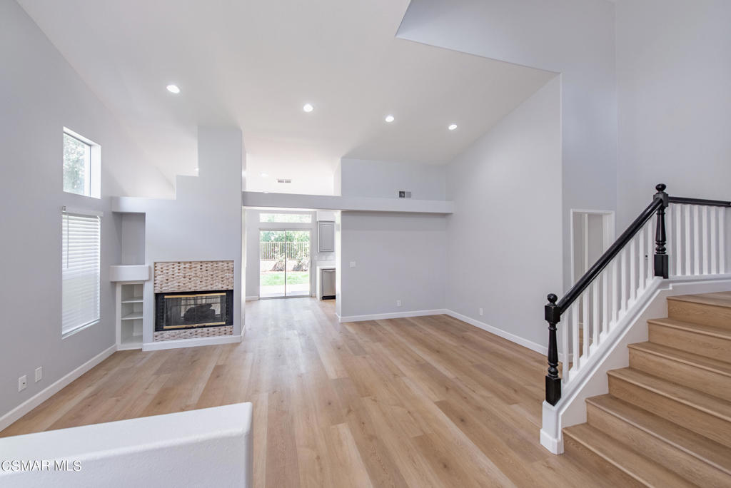 4774 Rhapsody Drive Oak Park, CA 91377 - Photo 3 of 34 a view of a livingroom with a fireplace wooden floor and window