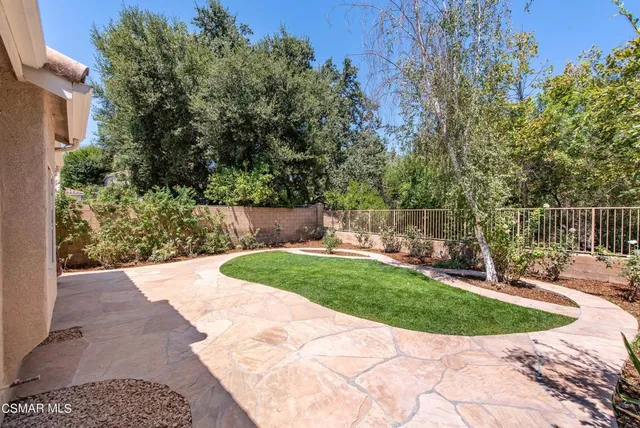 a view of a backyard with large trees