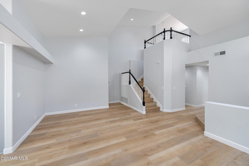 4774 Rhapsody Drive Oak Park, CA 91377 - Photo 5 of 34 a view of an empty room with wooden floor and staircase