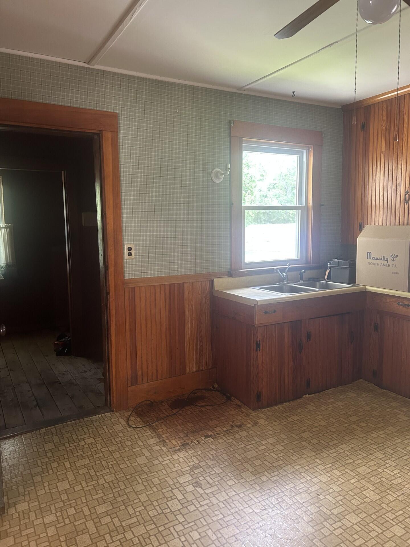 26 Bemis Street Livermore Falls, ME 04254 - Photo 8 of 22 0412 kitchen sink area and access to lau