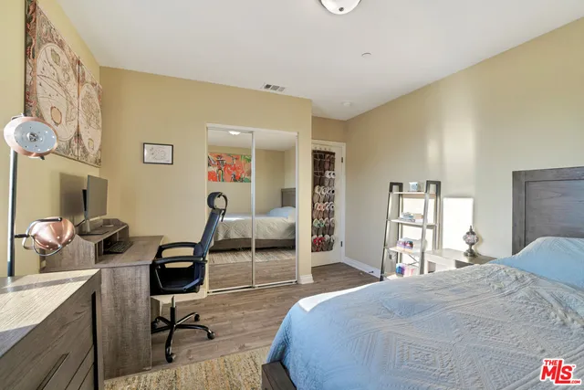 a bedroom with a bed and a television