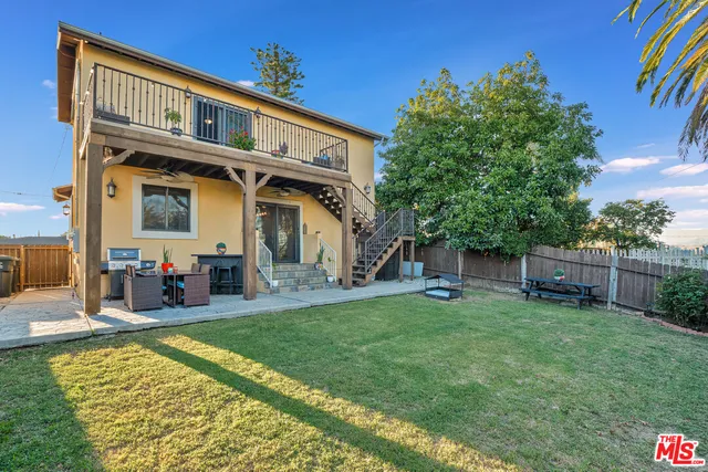 a backyard of a house with table and chairs