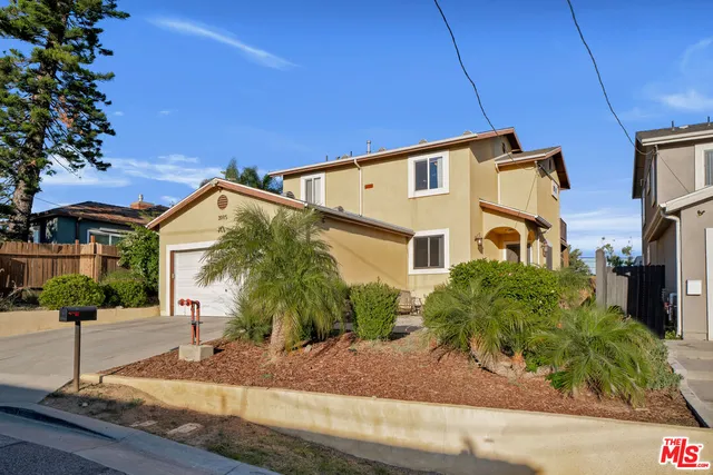 a view of a patio with table and chairs and potted plants