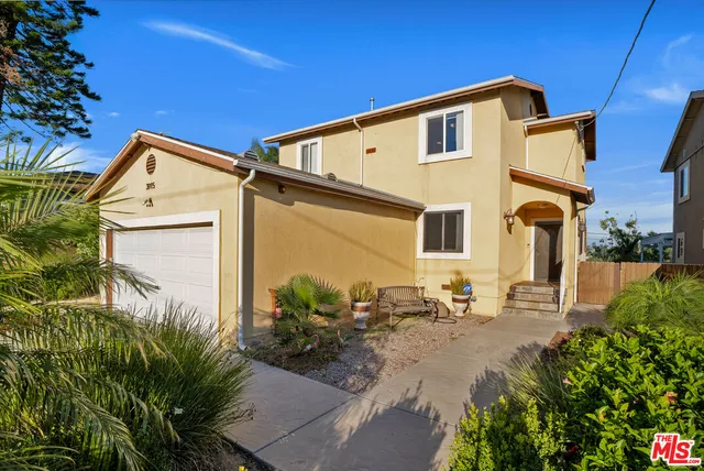 a view of a house with a yard porch and sitting area