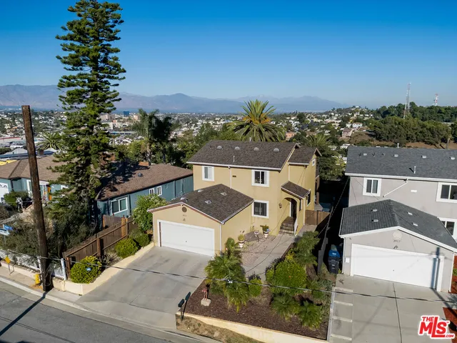 a front view of house along with yard and trees