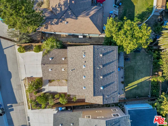 an aerial view of a city with lots of residential buildings and mountain view in back