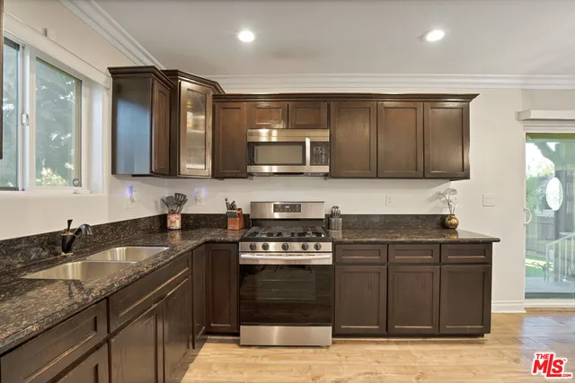 a kitchen with a sink and a stove top oven