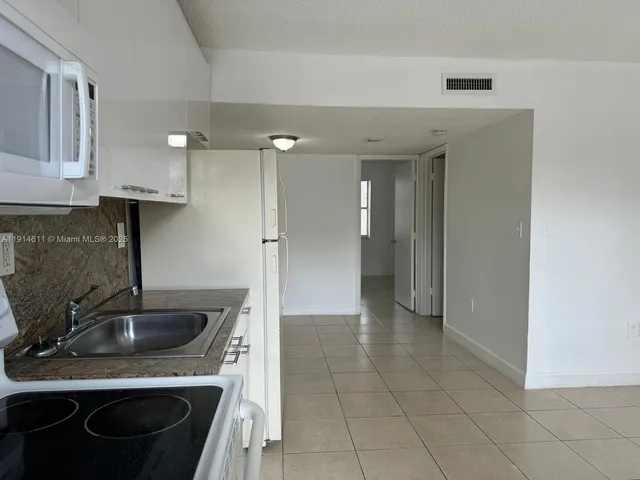a kitchen with a sink a stove and refrigerator