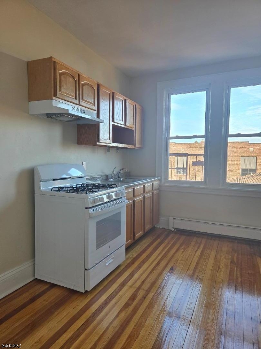 80 Union Avenue, Unit C6 Clifton, NJ 07011 - Photo 4 of 9 a kitchen with stainless steel appliances granite countertop a stove a sink and a refrigerator