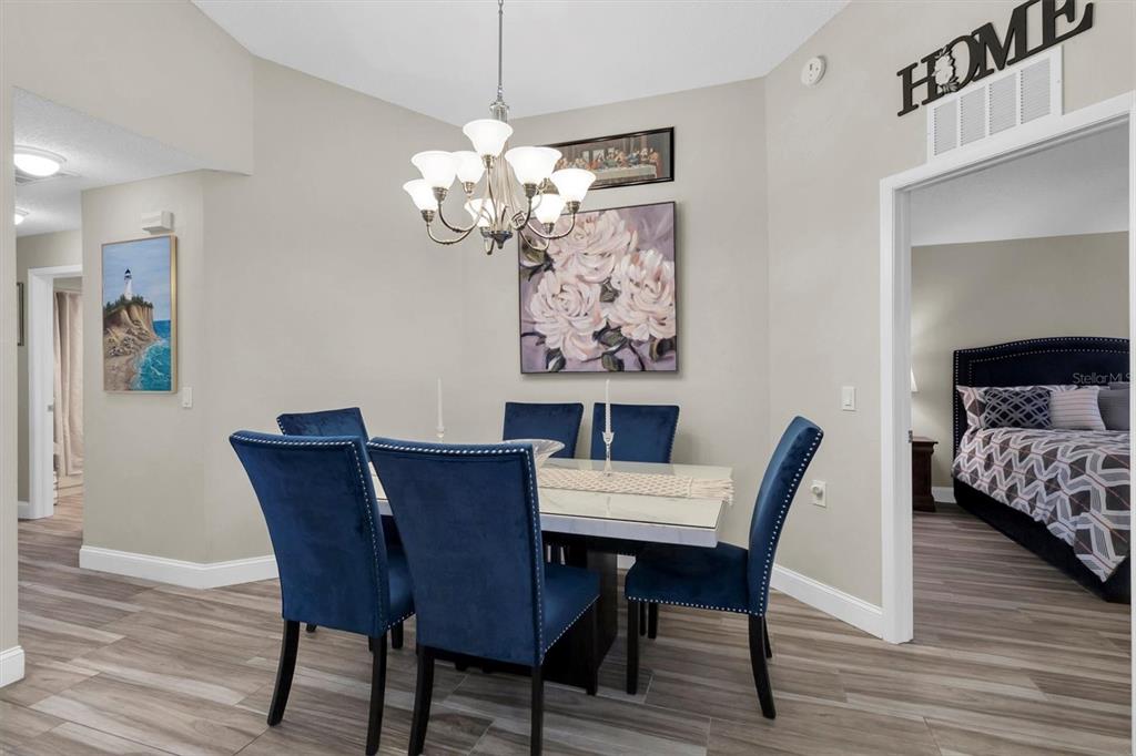 4638 Sheffield Drive New Port Richey, FL 34655 - Photo 11 of 67 a view of a dining room with furniture wooden floor and a chandelier