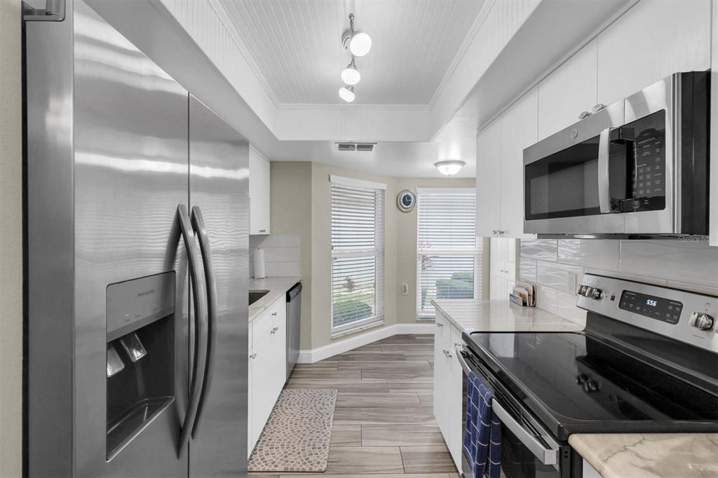 4638 Sheffield Drive New Port Richey, FL 34655 - Photo 12 of 67 a kitchen with stainless steel appliances granite countertop a stove and a refrigerator