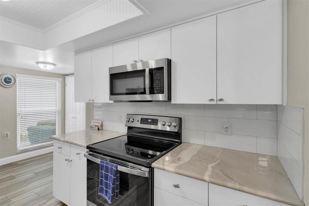 4638 Sheffield Drive New Port Richey, FL 34655 - Photo 13 of 67 a kitchen with a stove and a microwave