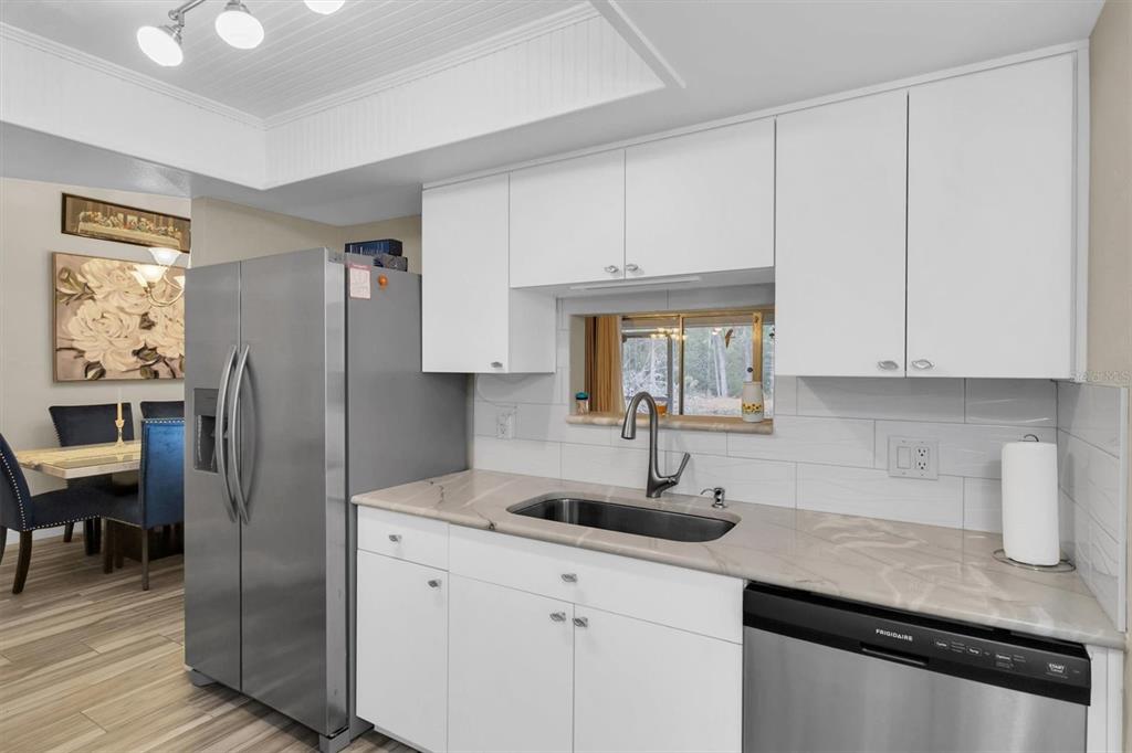 4638 Sheffield Drive New Port Richey, FL 34655 - Photo 14 of 67 a kitchen with stainless steel appliances white cabinets and a sink