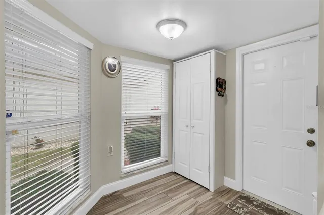 a bedroom with a bed and a lamp on dresser