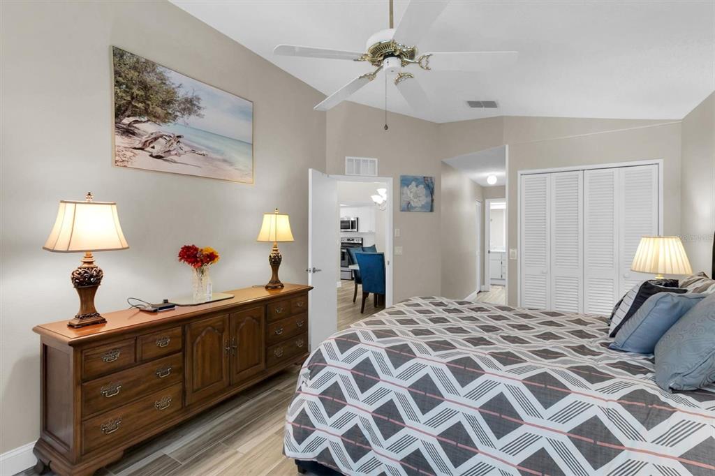 4638 Sheffield Drive New Port Richey, FL 34655 - Photo 19 of 67 a bedroom with bed and a chandelier