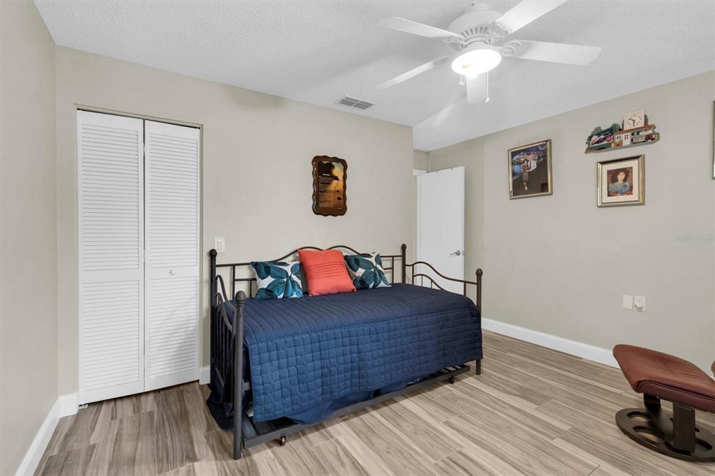 4638 Sheffield Drive New Port Richey, FL 34655 - Photo 24 of 67 a bedroom with a bed and a workspace