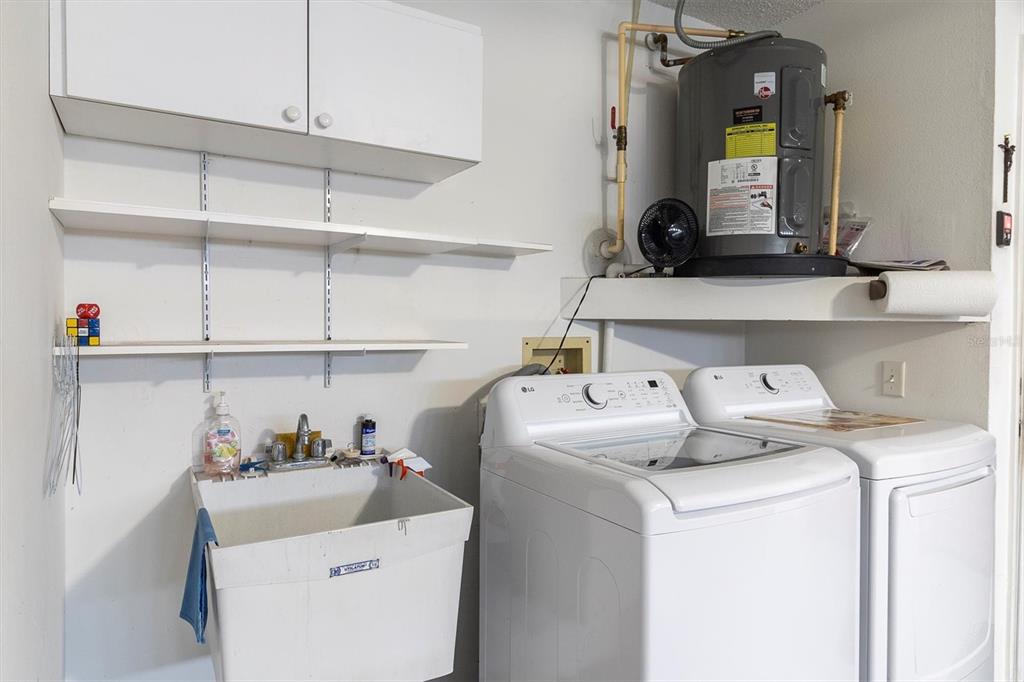 4638 Sheffield Drive New Port Richey, FL 34655 - Photo 26 of 67 a view of washer and dryer with kitchen countertop