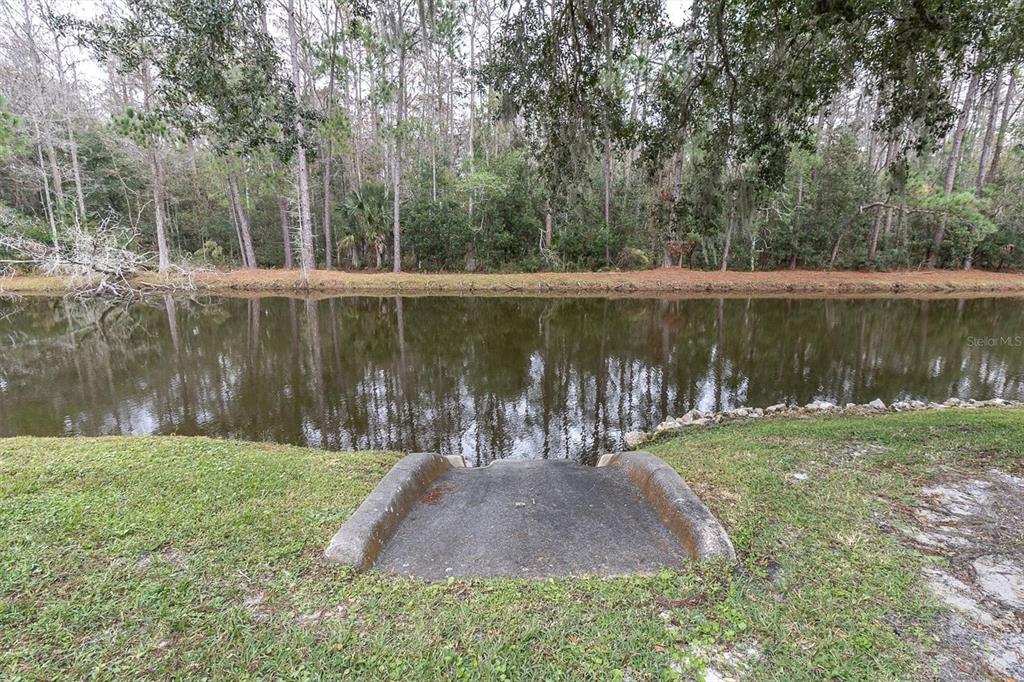 4638 Sheffield Drive New Port Richey, FL 34655 - Photo 33 of 67 a view of a lake with a yard and trees