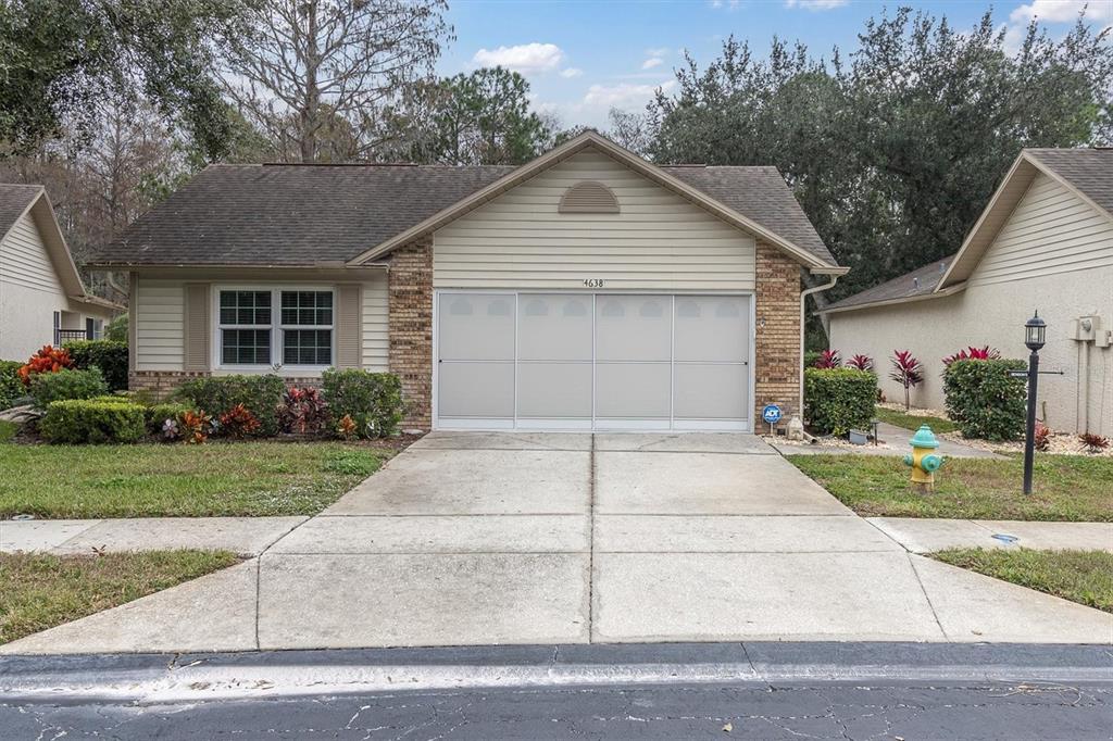 4638 Sheffield Drive New Port Richey, FL 34655 - Photo 40 of 67 a front view of house with garage and yard