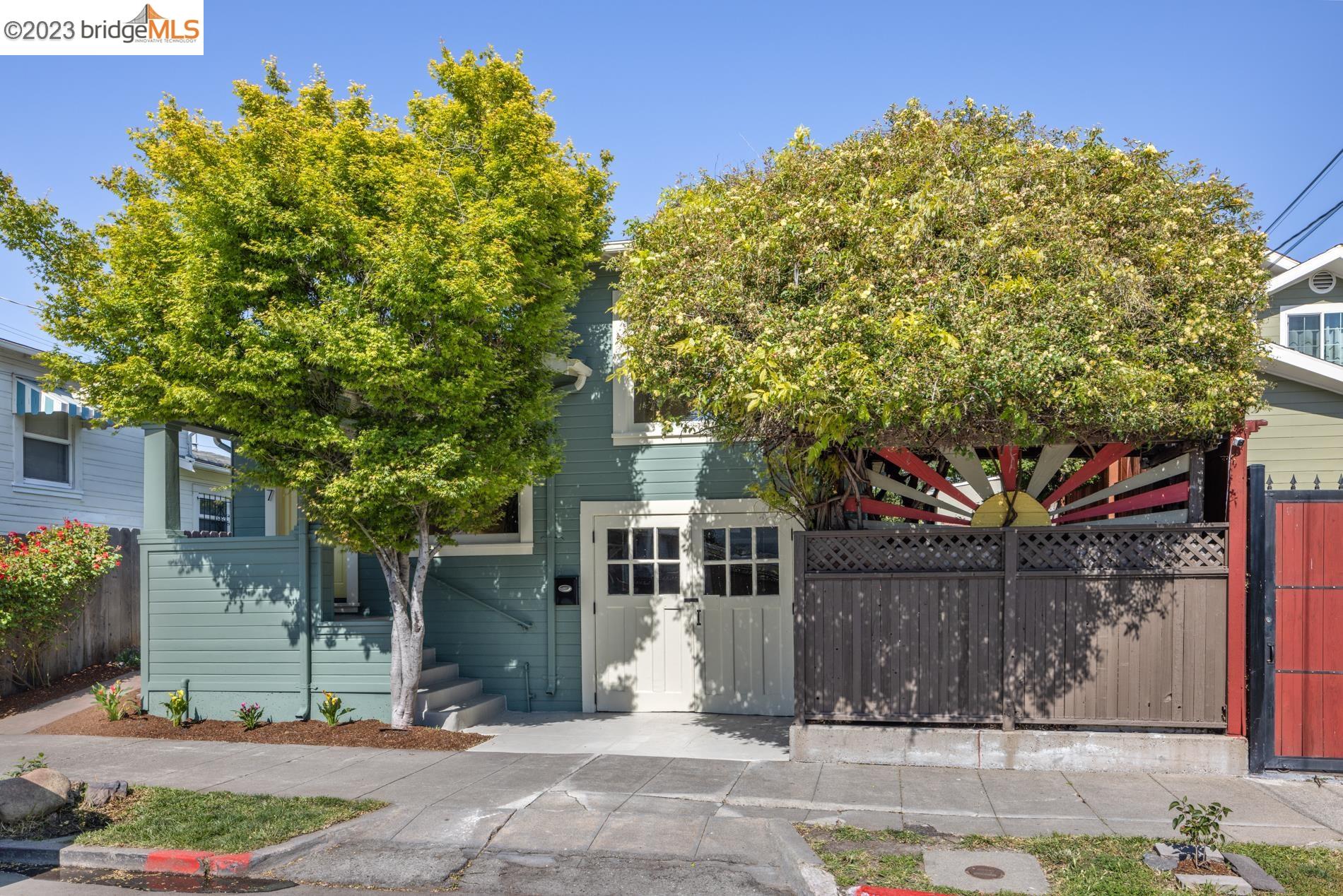 a front view of a house with a tree