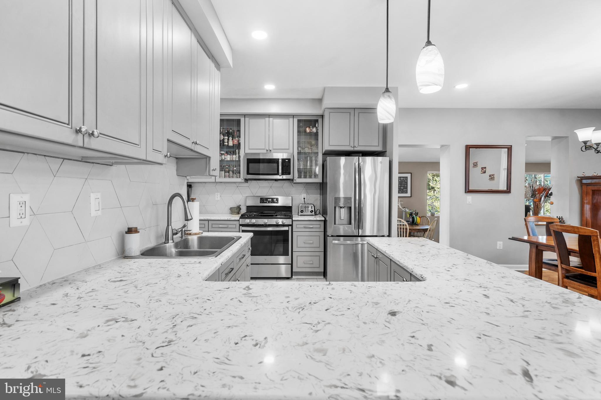 1118 Allston Road Havertown, PA 19083 - Photo 17 of 58 a kitchen with stainless steel appliances granite countertop a sink a stove and a refrigerator