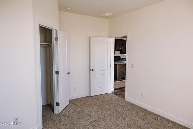 a view of empty room with closet