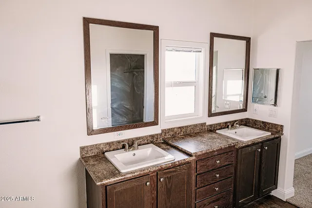 a view of walk in closet with wooden floor