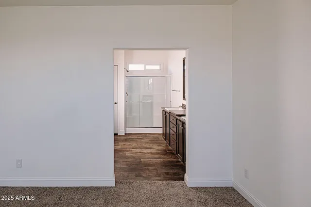 a view of an empty room and wooden floor