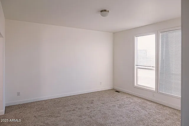 a kitchen with kitchen island granite countertop a sink a counter space appliances and cabinets