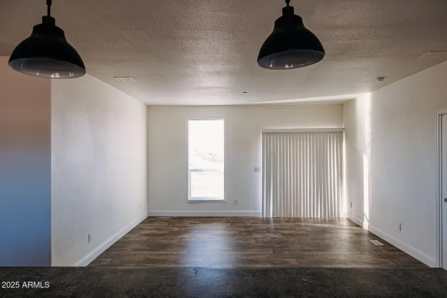 a large kitchen with stainless steel appliances kitchen island granite countertop a refrigerator and a stove