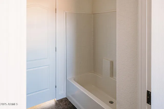 a bathroom with a tub and shower